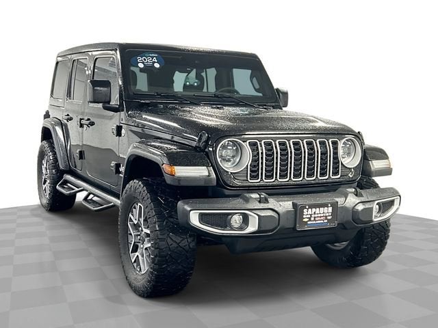 2024 Jeep Wrangler 4-Door Sahara 4x4 in Black — front three-quarter view